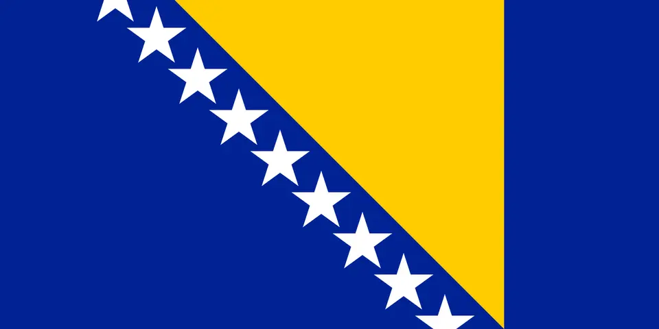 Modrá vlajka se žlutým trojúhelníkem a řadou bílých hvězd.